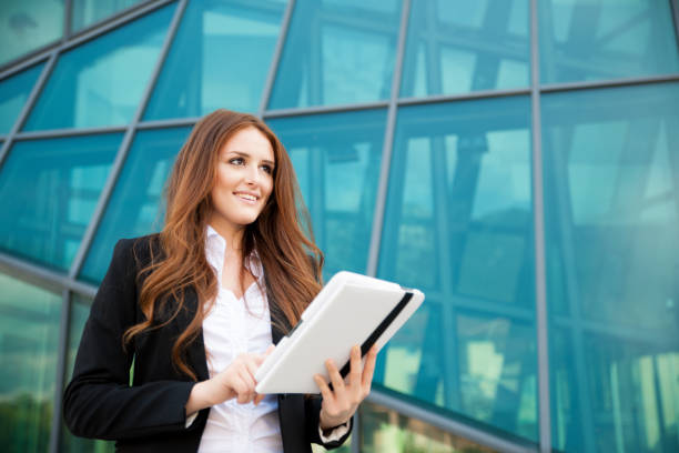 istock business woman checking data on her tablet computer outdoor 1202963428