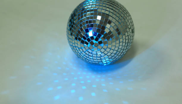 istock beautiful disco ball on yellow background isolated. 1202964495
