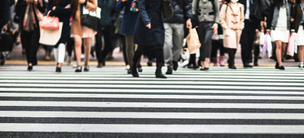 istock defocused people crossing the street 1202964626