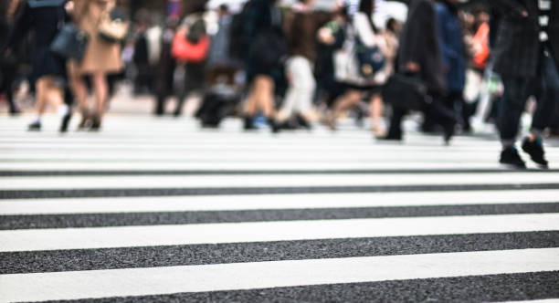 istock defocused people crossing the street 1202964728