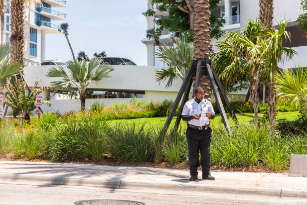 Security guard police officer man in city in North Miami, Florida Sunny Isles Beach, USA - May 8, 2018: Security guard police officer man in city in North Miami, Florida, on A1A Collins Avenue road street 1 hotel south beach stock pictures, royalty-free photos & images