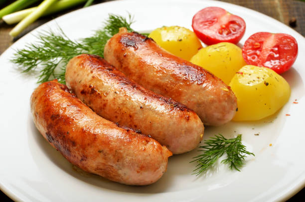 istock Grilled sausages and boiled potatoes 1202966668