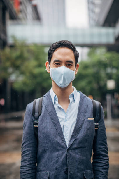 istock Gentleman with in coronavirus infected city wearing a pollution mask 1202966769