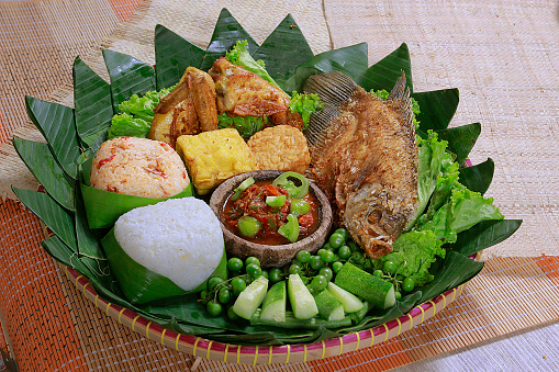 indonesian traditional food cuisine with fried fried chicken, sayur asem, and vegetables