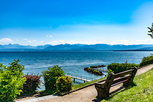The Alps near Lake Geneva, Switzerland.  This is viewed from the shore with jetties near Nyon looking  across a Bay on Lake Geneva.