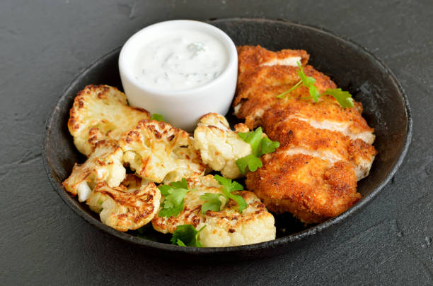 istock Chicken breast, fried cauliflower and sauce on plate 1202969004