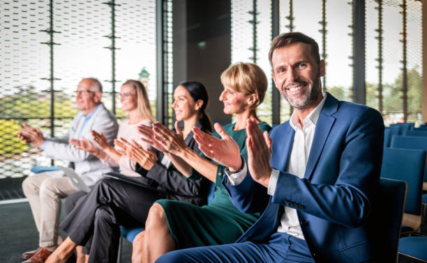 istock Happy audience applauding speaker at business conference 1202969969