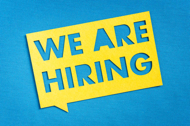 "WE ARE HIRING", Help wanted sign. Yellow speech bubble banner on blank blue textured background. Job vacant and employment concept with copy space. Concept of recruitment and job search "WE ARE HIRING", Help wanted sign. Yellow speech bubble banner on blank blue textured background. Job vacant and employment concept with copy space. Concept of recruitment and job search. help wanted sign stock pictures, royalty-free photos & images