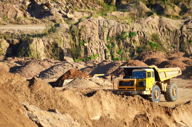 istock Dump truck transporting stone and gravel in an sand open-pit 1202971252