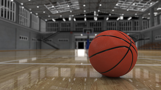 Basketball ball on shiny parquet flooring in high school court 3d render