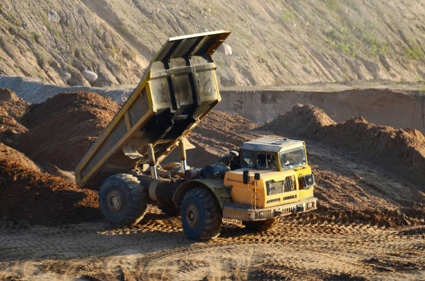 istock Dump truck transporting stone and gravel in an sand open-pit 1202971338