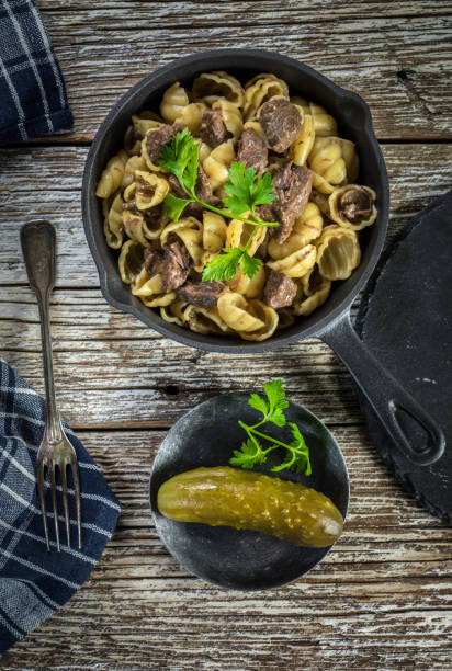 istock Italian pasta shells with beef sauce in cast iron pan. 1202971861