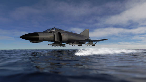 istock F-4 jet fighter low flying over sea side view 3d render 1202971947