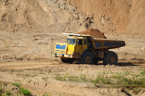 istock Dump truck transporting sand and gravel in open-pit mining 1202972207
