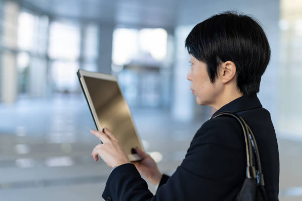 istock Asian businesswoman using tablet 1202973964