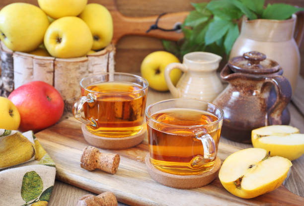 istock Two cups of Apple Cider and yellow apples 1202974347