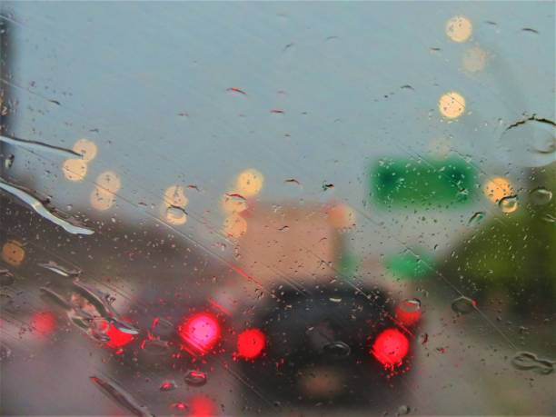 istock Rainy city road. View through the window on rainy day. 1202974723