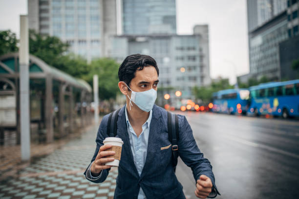 istock Gentleman with pollution mask in coronavirus infected city downtown 1202975947