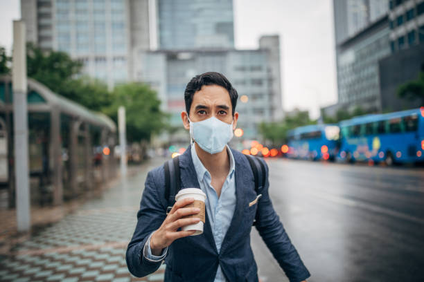 istock Gentleman with pollution mask in coronavirus infected city downtown 1202975957