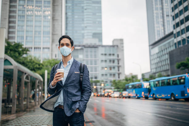 istock Gentleman with pollution mask in coronavirus infected city downtown 1202977121