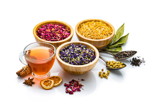 istock Herbal tea cup with various multi colored dried tea leaves and flowers isolated on white background 1202977670