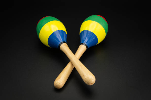 istock a pair of colorful maracas lying on a black underground 1202977774