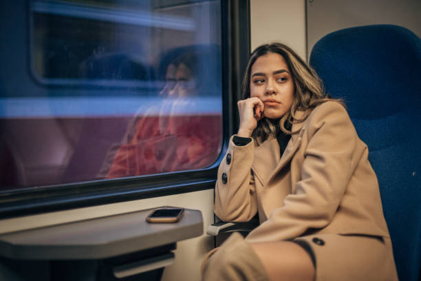 istock One young woman sitting in train 1202979176