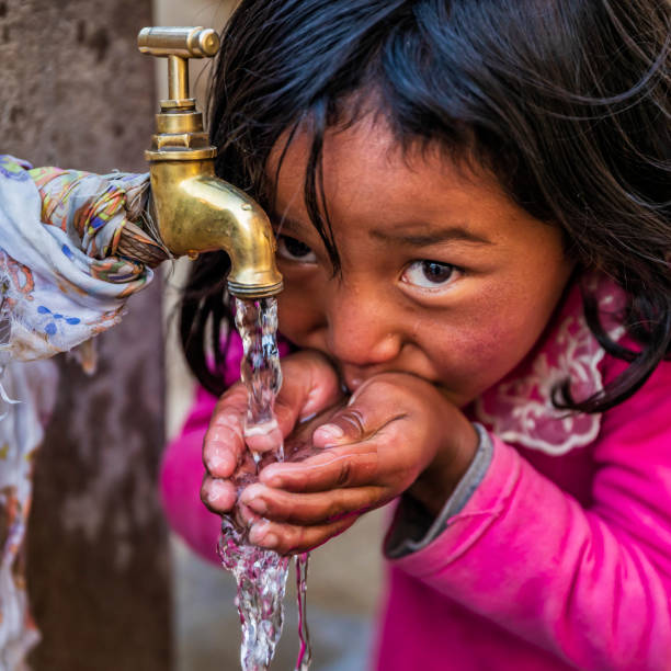 istock Nepalese girl drinking water, Upper Mustang, Nepal 1202980732