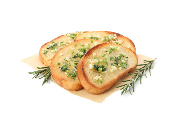 istock Baking paper with toasted garlic bread slices isolated on white background 1202981062
