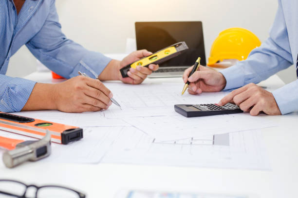 istock Businessman and engineer discuss at meeting about housing project. 1202981163