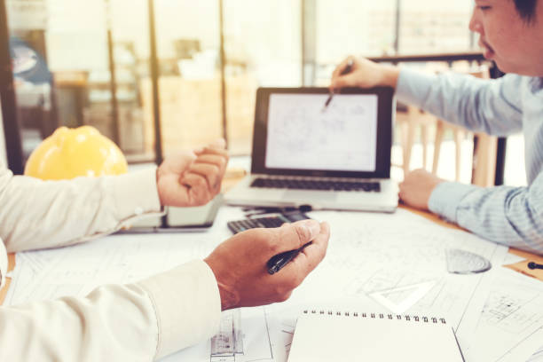 istock Engineers plan to complete construction create together in the meeting. 1202982129