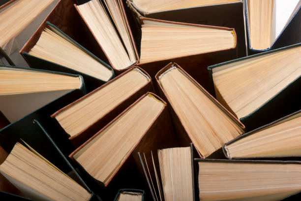 istock Open book, hardback books on wooden table. Back to school. Copy space. 1202983896