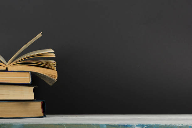 Open book, hardback books on wooden table. Back to school. Copy space.