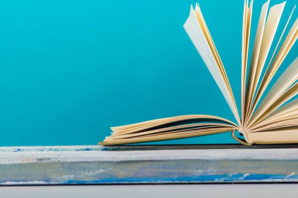 Open book, hardback books on wooden table. Back to school. Copy space.