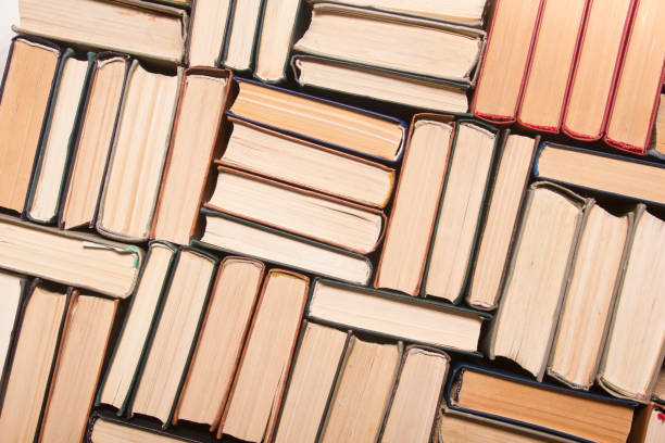 istock Open book, hardback books on wooden table. Back to school. Copy space. 1202985205