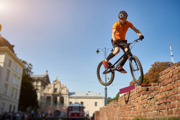 istock Freestyle biker jumping on a brick wall 1202986059
