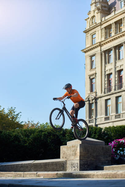 istock Fearless man showing trick on bicycle in city. 1202986100