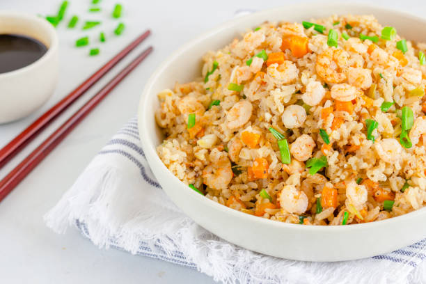 Shrimp Fried Rice in a White Bowl with Chopsticks Chinese Shrimp Fried Rice, Popular Chinese Take Out Food, in a Bowl with Chopsticks and Soy Sauce fried rice stock pictures, royalty-free photos & images