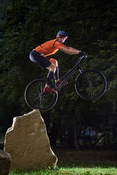 Mountain bike rider on his bicycle in mid air against the sky.