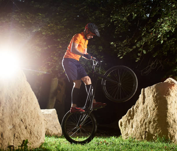 istock Biker performing tricks in the park 1202986692