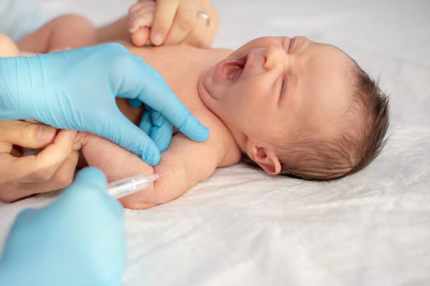 istock Pediatrician vaccinating newborn baby at shoulder. 1202987237