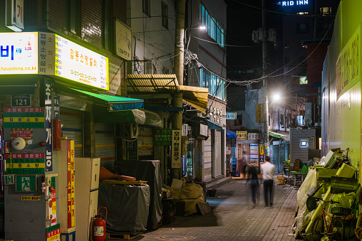 People walking through the quiet back streets of central Seoul, South Korea’s vibrant capital city.