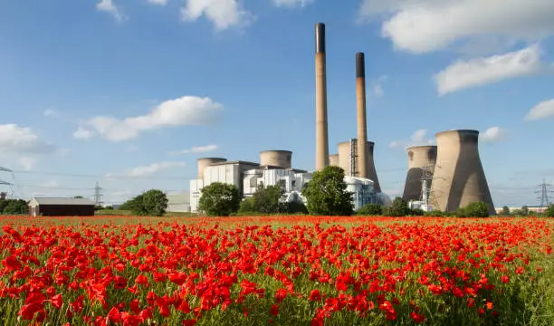 Ferrybridge Power station in England with a red poppy field in foreground