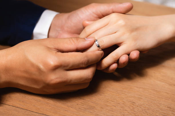 istock Man wearing the wedding ring to woman finger. 1202995273