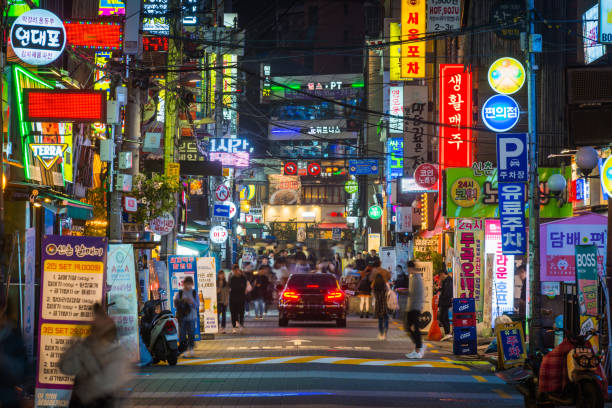 Seoul crowded streets of Sinchon nightlife neon signs South Korea People on the crowded neon night streets of Sinchon in the heart of Seoul, South Korea’s vibrant capital city. seoul stock pictures, royalty-free photos & images