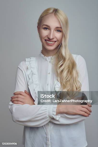 Young Longhaired Blond Woman With Her Arms Folded Stock Photo - Download Image Now - Application Form, Job Search, Photographic Print