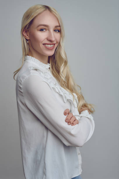 istock Young smiling blond woman with her arms folded 1203004915