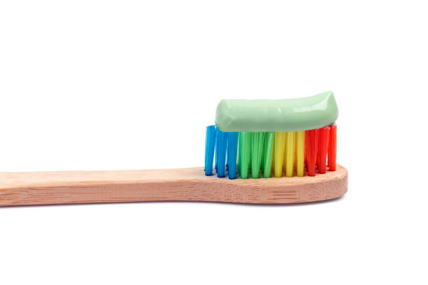 bambusowa szczoteczka do zębów z zieloną pastą do zębów makro izolowana - toothbrush dental hygiene dental equipment rainbow zdjęcia i obrazy z banku zdjęć