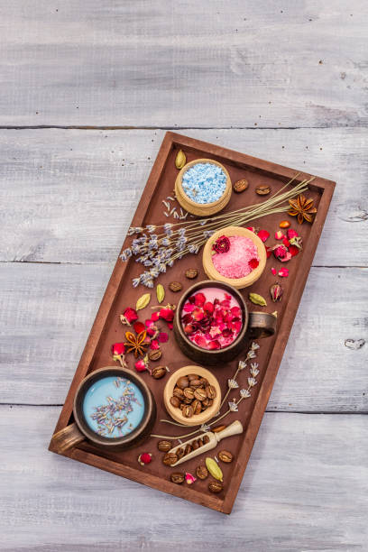 istock Set of romantic colored coffee latte for two lovers. Lavender and rose, powdered aromatic sugar, spices. Valentines Day concept. Tray, wooden boards background 1203006134