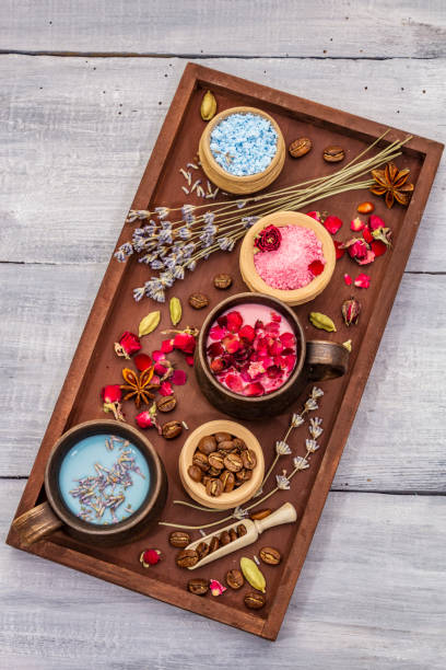 istock Set of romantic colored coffee latte for two lovers. Lavender and rose, powdered aromatic sugar, spices. Valentines Day concept. Tray, wooden boards background 1203006434